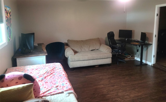 living area with baseboards and dark wood finished floors