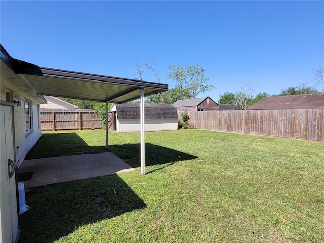view of yard with a fenced backyard and an outbuilding