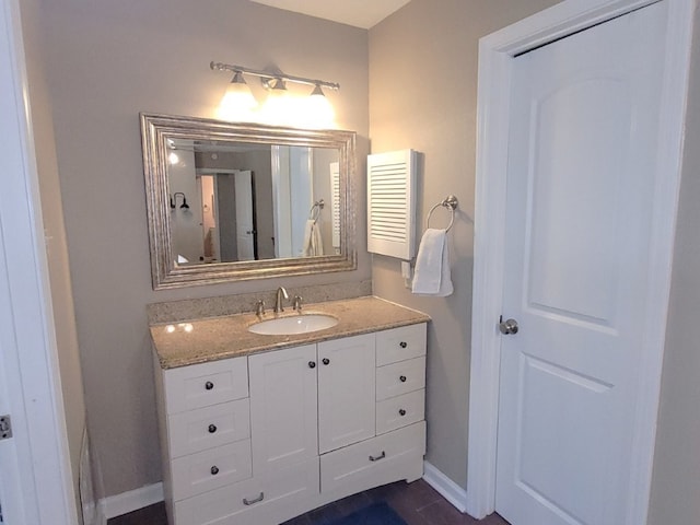 bathroom with baseboards and vanity