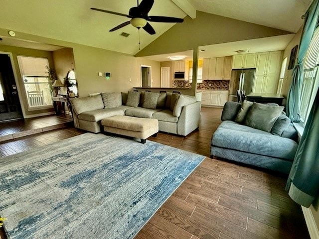 living area with visible vents, beam ceiling, high vaulted ceiling, a ceiling fan, and dark wood finished floors
