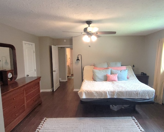 bedroom featuring baseboards, ceiling fan, dark wood-style flooring, and a textured ceiling