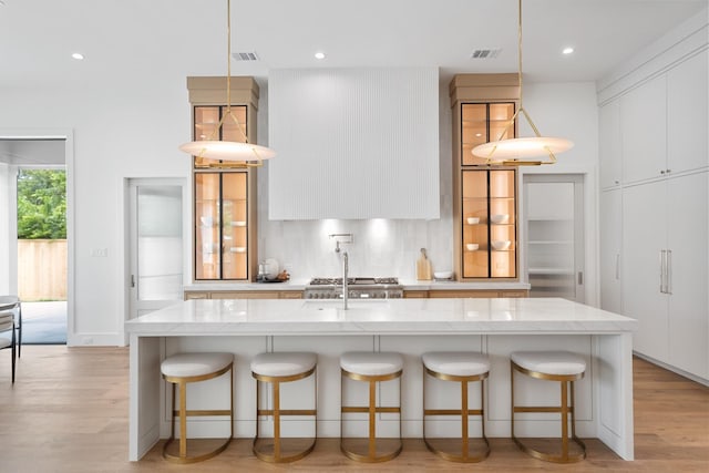216 W 31st St, Houston, TX 77018 - kitchen featuring modern cabinets, light wood-style floors, light stone countertops, tasteful backsplash, and recessed lighting