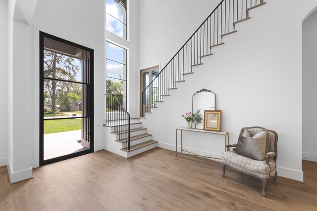 216 W 31st St, Houston, TX 77018 - entrance foyer with wood finished floors, stairs, baseboards, and a high ceiling