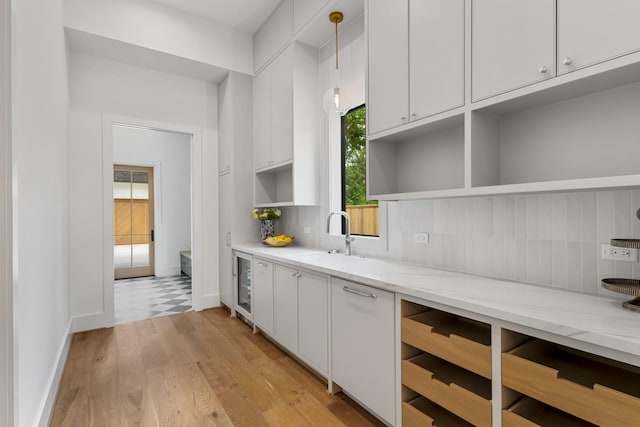 216 W 31st St, Houston, TX 77018 - kitchen featuring a sink, open shelves, beverage cooler, white cabinetry, and decorative backsplash