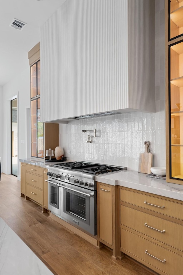 216 W 31st St, Houston, TX 77018 - kitchen with decorative backsplash, light countertops, and range with two ovens