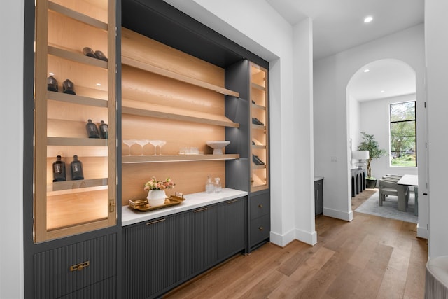 216 W 31st St, Houston, TX 77018 - indoor bar with light wood-style flooring, arched walkways, baseboards, and recessed lighting
