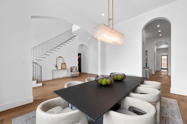216 W 31st St, Houston, TX 77018 - dining area featuring arched walkways, stairway, wood finished floors, recessed lighting, and baseboards