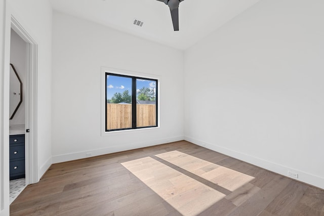 216 W 31st St, Houston, TX 77018 - empty room with wood finished floors, baseboards, and a ceiling fan