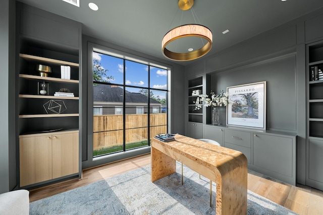 216 W 31st St, Houston, TX 77018 - office featuring built in shelves and wood finished floors