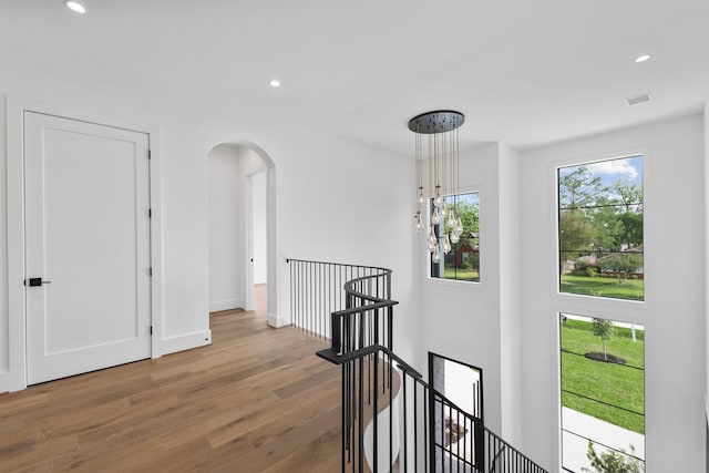 216 W 31st St, Houston, TX 77018 - hallway featuring an upstairs landing, arched walkways, wood finished floors, recessed lighting, and baseboards