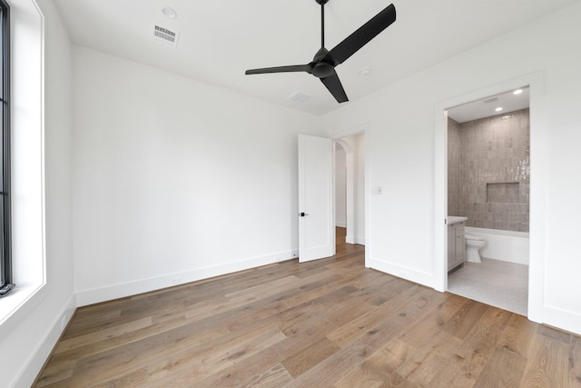 216 W 31st St, Houston, TX 77018 - unfurnished bedroom featuring light wood-style flooring, baseboards, ensuite bathroom, ceiling fan, and recessed lighting