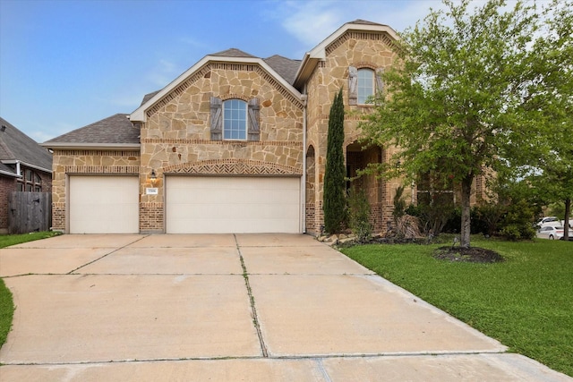 view of front of property featuring a shingled roof, driveway, stone siding, brick siding, and a front yard
