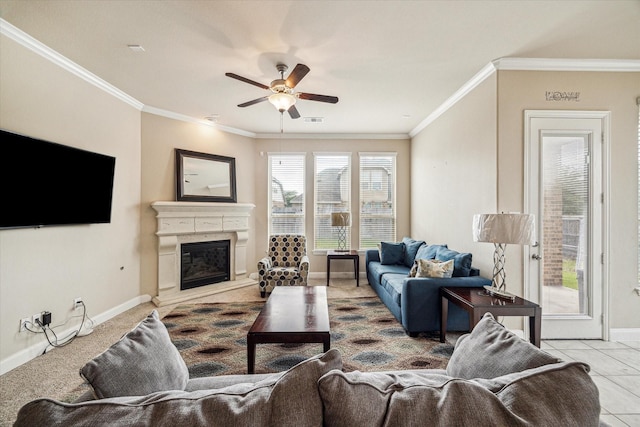 living area with ceiling fan, baseboards, crown molding, and visible vents