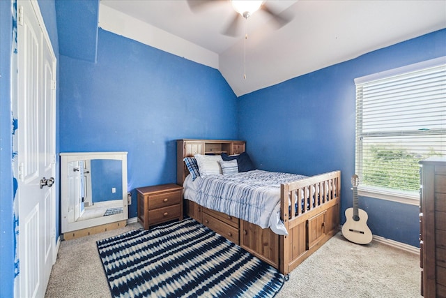 carpeted bedroom with lofted ceiling, baseboards, and ceiling fan