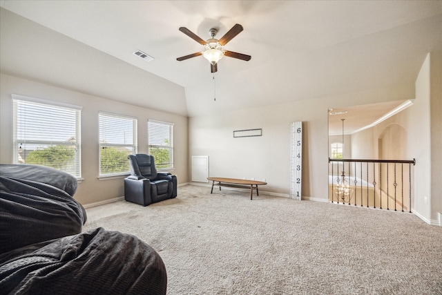 living area featuring lofted ceiling, carpet flooring, visible vents, and ceiling fan