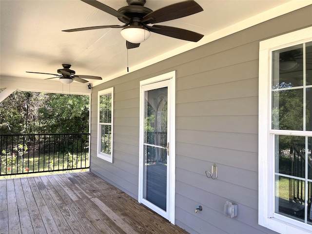 wooden deck with a ceiling fan
