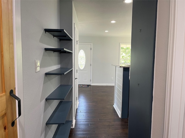 corridor featuring recessed lighting, baseboards, and dark wood-style floors