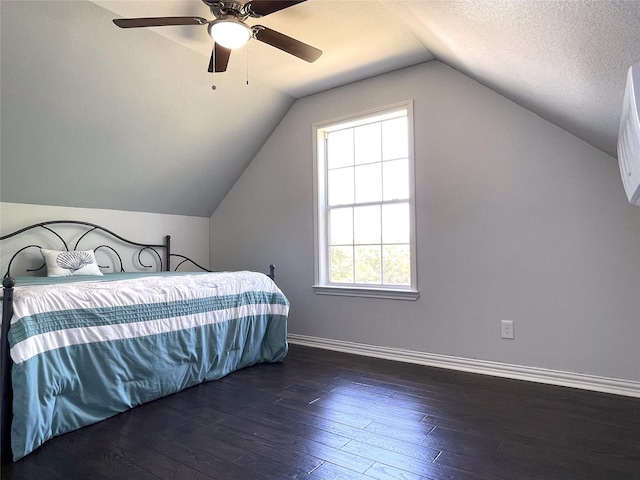 bedroom with hardwood / wood-style flooring, ceiling fan, vaulted ceiling, and baseboards