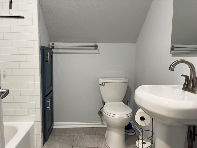 full bathroom featuring vaulted ceiling, toilet, tile patterned floors, and baseboards