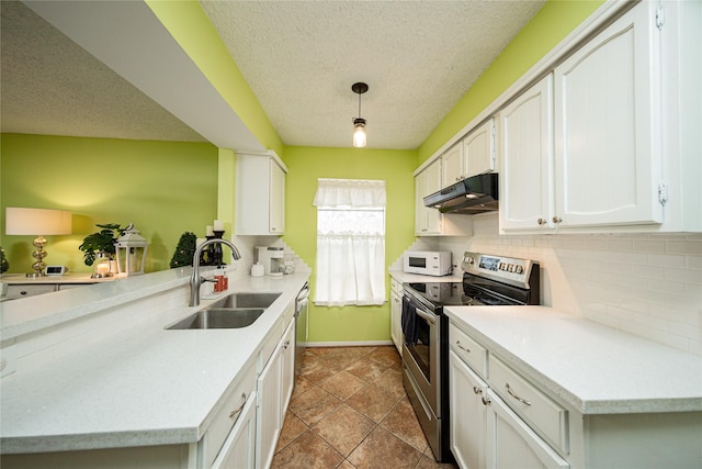 kitchen featuring under cabinet range hood, dishwasher, a sink, white microwave, and stainless steel electric stove