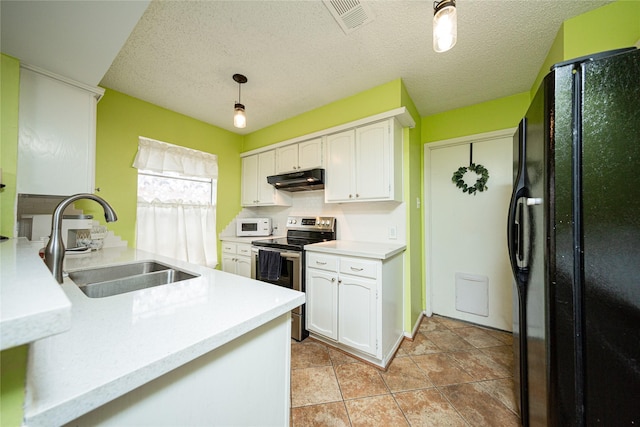 kitchen featuring a sink, stainless steel range with electric stovetop, white cabinetry, under cabinet range hood, and freestanding refrigerator