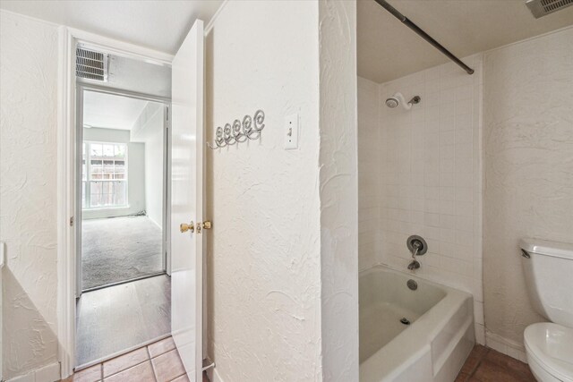 351 N Post Oak Ln Unit 617, Houston, TX 77024 - full bath featuring toilet, a textured wall, shower / tub combination, and visible vents