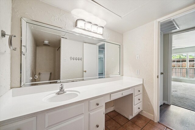 351 N Post Oak Ln Unit 617, Houston, TX 77024 - bathroom with a textured wall, visible vents, vanity, and toilet