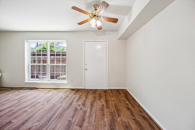 351 N Post Oak Ln Unit 617, Houston, TX 77024 - spare room with baseboards, wood finished floors, and ceiling fan