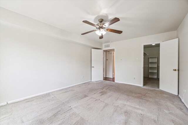 351 N Post Oak Ln Unit 617, Houston, TX 77024 - unfurnished bedroom with baseboards, visible vents, ceiling fan, carpet floors, and a walk in closet