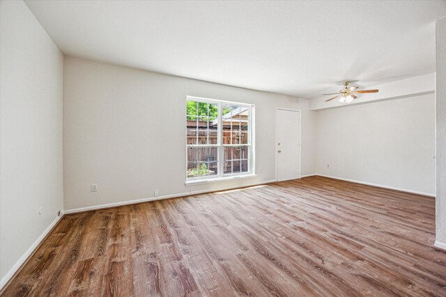 351 N Post Oak Ln Unit 617, Houston, TX 77024 - spare room featuring baseboards, wood finished floors, and ceiling fan