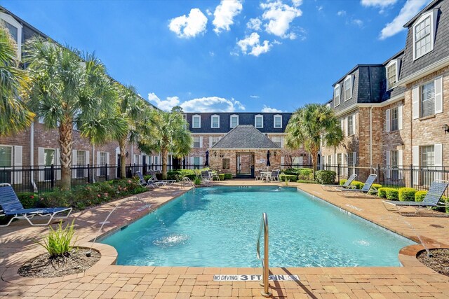 351 N Post Oak Ln Unit 617, Houston, TX 77024 - community pool featuring fence, a patio area, and a residential view