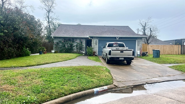 ranch-style home featuring concrete driveway, an attached garage, and a shingled roof
