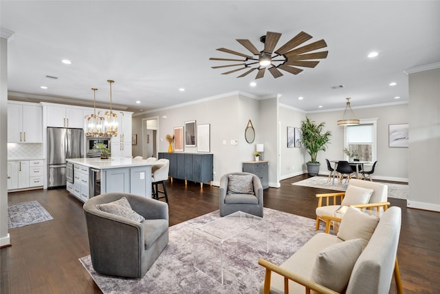 living room featuring wine cooler, baseboards, ceiling fan with notable chandelier, and recessed lighting
