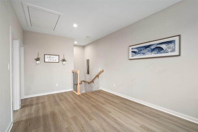 empty room featuring recessed lighting, baseboards, and light wood-style flooring