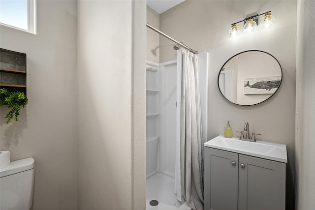full bath with vanity, toilet, and a shower stall