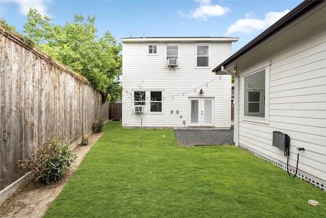 rear view of property with a yard and a fenced backyard