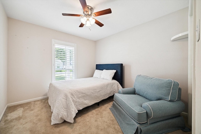 bedroom featuring baseboards, light colored carpet, and ceiling fan