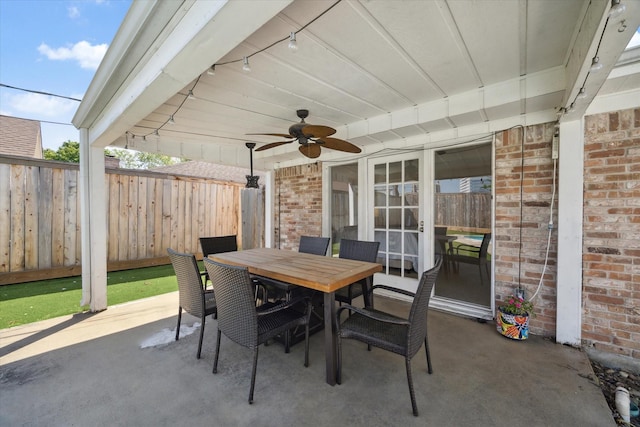 view of patio / terrace featuring a fenced backyard, a ceiling fan, and outdoor dining space