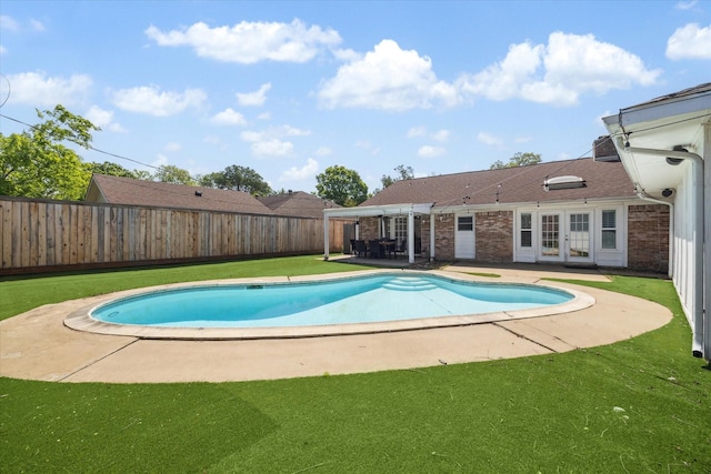 view of swimming pool with a fenced in pool, a fenced backyard, a patio area, french doors, and a lawn