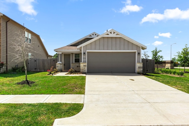 craftsman inspired home with a front lawn, fence, stone siding, and a garage