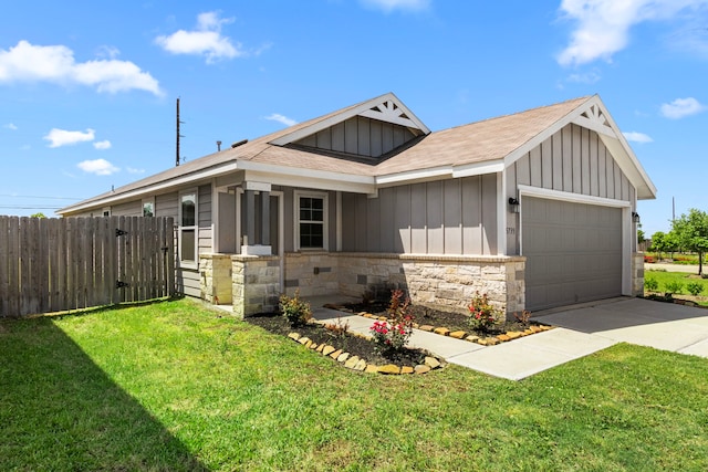 view of front facade featuring a front lawn, stone siding, fence, a garage, and board and batten siding