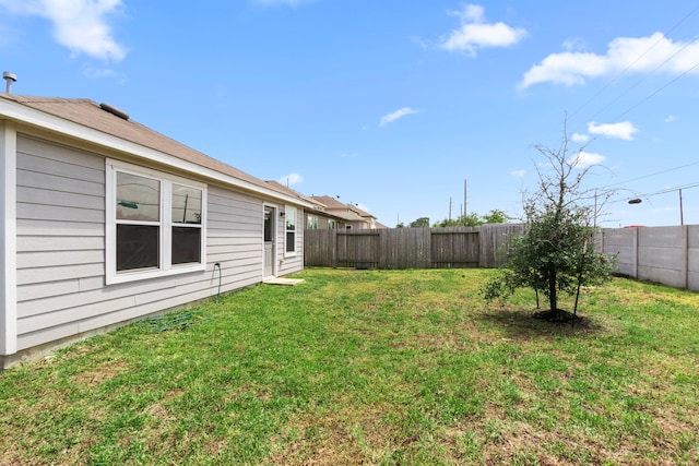 view of yard with a fenced backyard