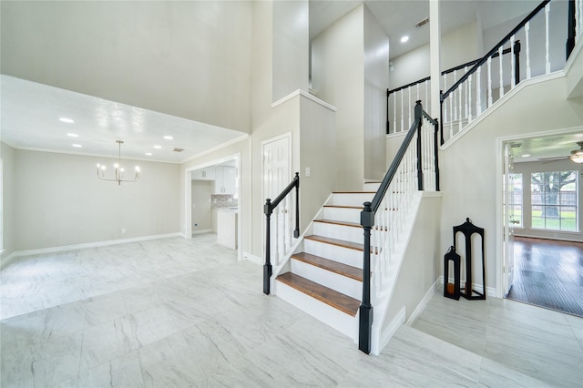 staircase with a high ceiling, baseboards, and recessed lighting