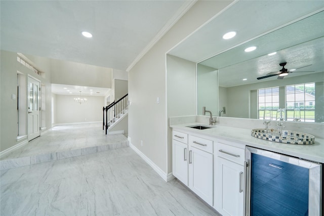 bar with baseboards, a sink, wine cooler, and recessed lighting