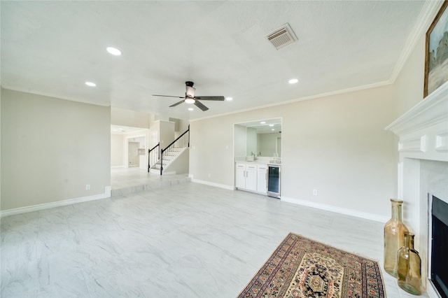 unfurnished living room with wine cooler, visible vents, a premium fireplace, a ceiling fan, and stairway