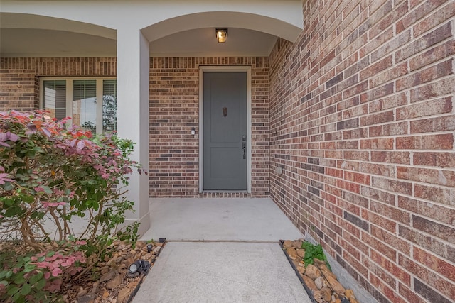 entrance to property with brick siding