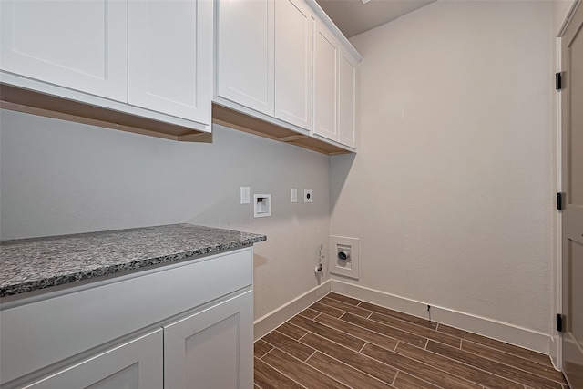 clothes washing area with electric dryer hookup, cabinet space, baseboards, dark wood-style floors, and washer hookup