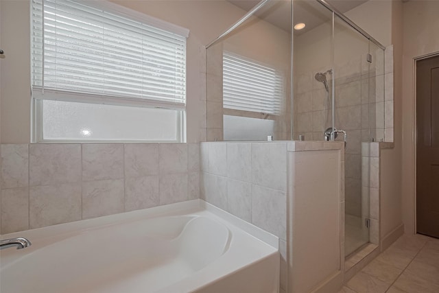 full bath featuring a bath, tile patterned flooring, and a shower stall