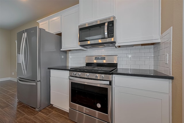 kitchen featuring white cabinets, tasteful backsplash, baseboards, wood tiled floor, and appliances with stainless steel finishes