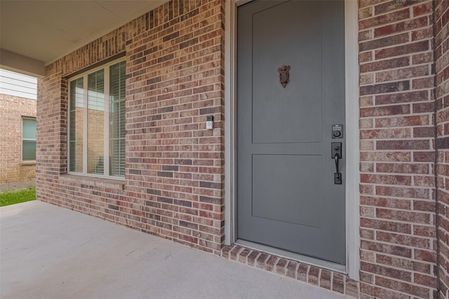 entrance to property with brick siding